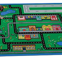 A child playing on a kids rug with towns and streets.