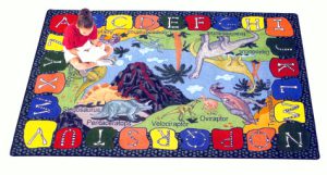 A child sitting on a rug reading a book.