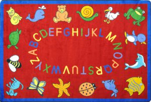 A red rectangle kids rug with animals and alphabet around the edge.