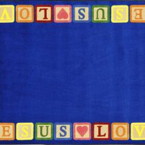 A faith based childrens rug that says Jesus loves me in play blocks around the edge.