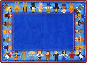 A blue kids rug with children of many cultures holding hands around the border.