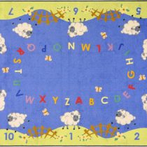 An alphabet rug with numbers and several lamb.